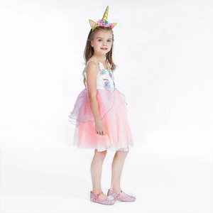 Close-up detail of unicorn dress with 3D floral appliques and layered tulle skirt
