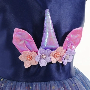 Détail du corsage licorne avec corne arc-en-ciel et fleurs 3D sur robe satin marine