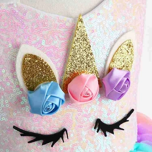 Vue détaillée de la robe licorne à paillettes avec fleurs en ruban et corne dorée