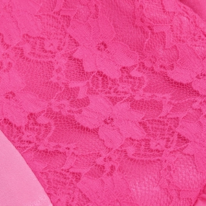 Close-up of bright rose pink floral lace fabric and mesh texture on girl's princess dress
