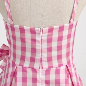 Detailed back view of pink plaid dress featuring invisible zipper and waist bow detail