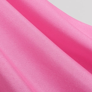 Detailed macro view of bright pink textured chiffon fabric for girls princess dress