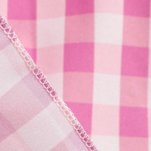 Macro detail of pink and white checkered fabric showing high-quality stitching and texture