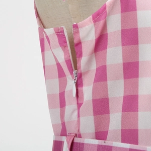 Close-up of invisible zipper detail on pink and white plaid girls princess dress