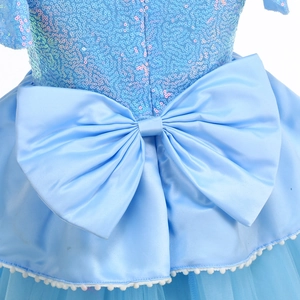 Detail of the light blue princess dress featuring a large satin bow and sequined fabric
