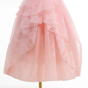 Detailed view of pink princess dress featuring layered tulle with white star and moon prints