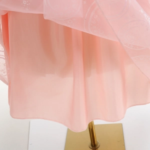 Detail of pink Glinda dress with silver star and moon glitter pattern on tulle fabric
