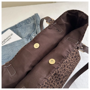 Détail du sac cabas léopard avec doubles boucles magnétiques dorées et bandoulière
