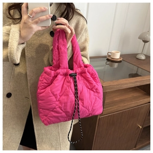 Detail of rose pink quilted tote bag with heart patterns and drawstring closure