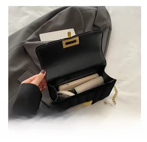 Detail view showing large interior capacity of black quilted chain strap flap shoulder bag