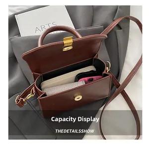 Interior capacity of dark brown vintage faux leather handbag with phone and wallet