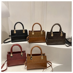 Detail of vintage flap bags in five colors with woven handles and gold hardware