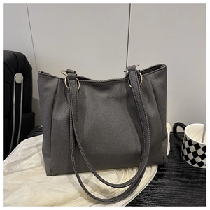 Close-up of a large dark grey canvas tote bag with metal ring strap connectors