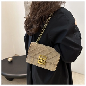 Detail of vintage khaki suede crossbody bag with gold chain and quilted stitching