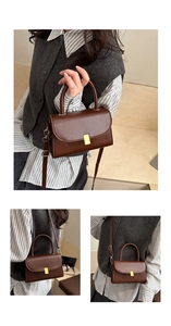 Close-up of brown leather handbag with gold buckle showing top handle and shoulder strap