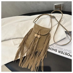 Détail du sac bandoulière en daim kaki avec de longues franges et perles en bois