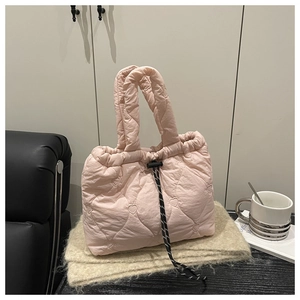 Detail of pink quilted nylon handbag with heart pattern stitching and adjustable drawstring