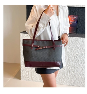 Detail of color-block tote bag with dark grey weave texture and burgundy leather trim