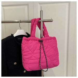 Detail of rose pink quilted tote bag with heart embroidery and drawstring closure