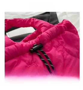 Detail of rose red quilted tote bag featuring heart stitching and striped drawstring
