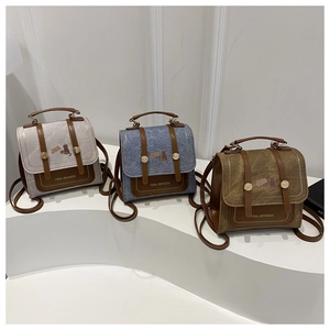 Detailed view of mini backpacks in grey, blue, and green with cute cat illustrations