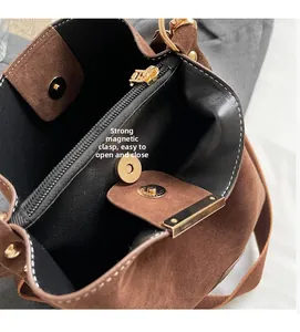 Top-down view of retro bucket bag interior showing magnetic clasp and zipper pocket