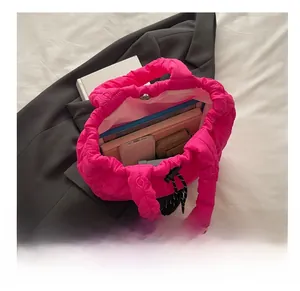 Deep pink quilted tote bag showing large capacity with laptop and mobile phone inside