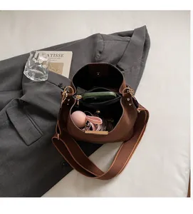 Internal view of brown suede bucket bag showing large capacity and zipper pocket