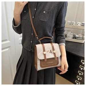 Retro messenger bag featuring cute cat embroidery and stylish leather stitching detail