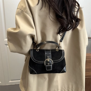 Vintage black crossbody handbag with white contrast stitching and gold ring buckle