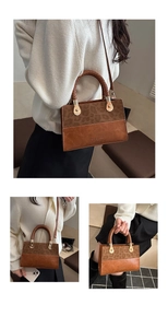 Detail of leopard print patchwork handbag with braided handle and golden hardware