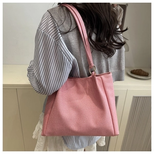 Detail view of the pink canvas tote bag showing the metal ring strap connection