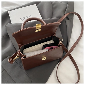 Interior view of brown leather crossbody bag showing capacity for phone and essentials