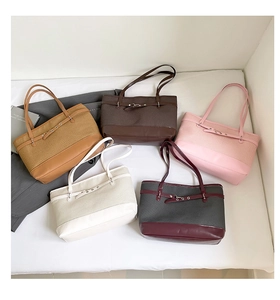 Detail showing five different colorways of textured woven and faux leather tote bags