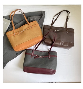 Detailed view of woven tote bags with leather trim in three color combinations