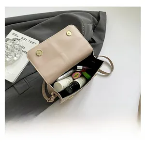 Interior view of beige crossbody bag showing ample capacity for phone and makeup