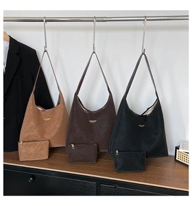 Detailed set of matte tote bags in camel, brown, and black with small inner pouches