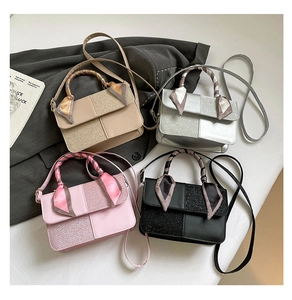 Detailed view of four colorful square crossbody bags with silk scarf wrapped handles