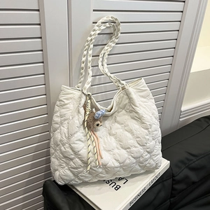 Quilted heart pattern white tote bag with woven straps and plush bear charm accent