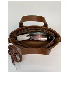 Top view of the brown straw bucket bag showing interior pocket and large capacity