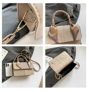 Detail of light beige square bag showing gold hardware and scarf-wrapped handle