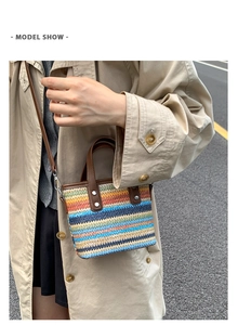 Detail of colorful rainbow woven straw bucket bag with dark brown leather straps