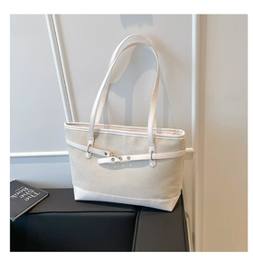 Detail of beige woven tote bag with white leather contrast and decorative buckle