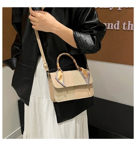 Detail showing beige patchwork handbag with sequined texture and silk scarf handle