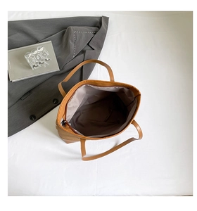 Spacious interior of the tote bag with dark lining and zipper closure for storage