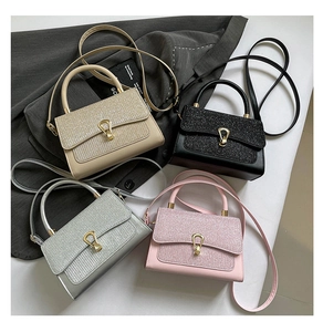 Detailed view of four colorful mini square bags with sequin flaps and golden U-shaped buckles