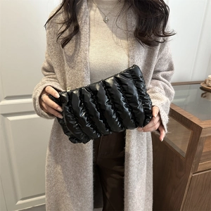 Glossy black pleated cloud clutch bag with quilted design and top zipper closure