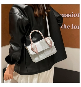 Silver patchwork small square bag with silk scarf handle detail worn by a model