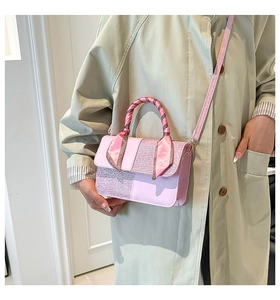Close-up of pink handbag with sequin panel, silk scarf handle and detachable strap