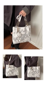 Detail of printed shoulder bag featuring moon star patterns and cloud plush charm